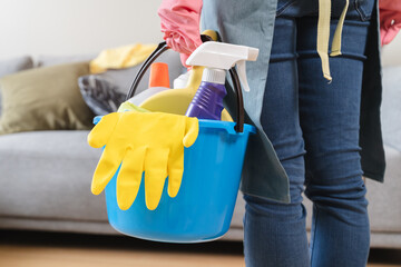 happy Female housekeeper service worker mopping living room floor by mop and cleaner product to...