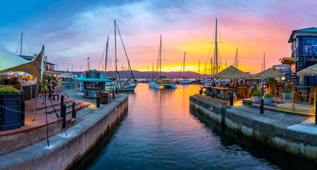 View of golden sunset, boats and restaurants at Knysna Waterfront, Knysna, Western Cape Province, South Africa