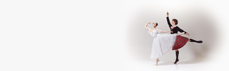 Banner. Ballerina in ethereal dress and floral crown and her partner in kilt posing against white...