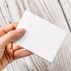 Obraz premium Enhance your presentation with this elegant mockup featuring two hands delicately holding diagonally opposite corners of a sheet of paper