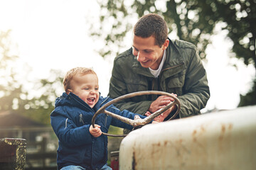 Father and teaching son to drive tractor for farming education, learning and bonding in nature. Excited, dad and kid with smile on harvest vehicle for lesson, agriculture knowledge and fun together