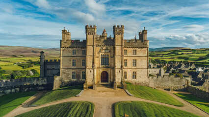 A stunning ultra-wide-angle shot capturing a historic castle sitting proudly on a hilltop.
