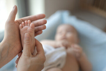 Mother massaging her child's foot, shallow focus