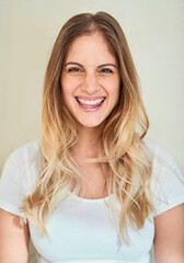 Portrait, smile and woman with cheeky expression in studio for goofy, smirk and mischievous as comedian. Confident, female person and toothy attitude with positive personality on white background