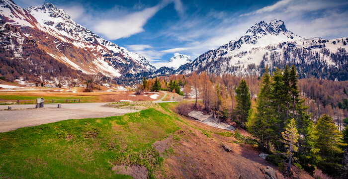Parking on the top of Maloya pass. Cold morning scene of Swiss Alps at April, Upper Engadine in canton of the Grisons, Switzerland, Europe. Beauty of nature concept background..