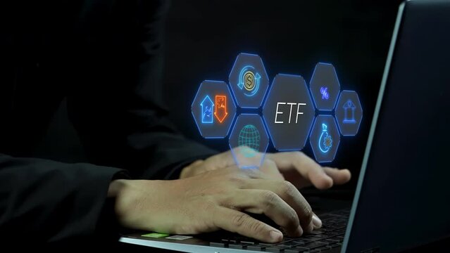 ETF, Exchange traded fund concept. Business stock market finance index fund. Businessman working with laptop to show ETF icons on virtual screen.
