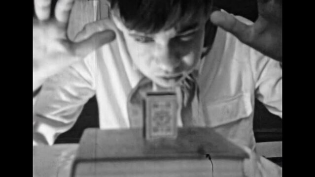 Archive film, person move things with thought power. Telepathy, telekinesis, thought magic. Children's magic games as wizard. Man concentrating brain, idea. Vintage black white movies. Retro 1980s. 4k