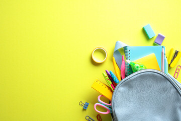 Back to School concept: Colorful school supplies including backpack, notebooks, pencils, scissors,...