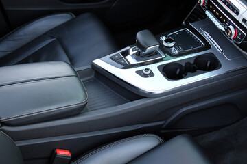 Luxury SUV leather armrest. Cup holders and Selector automatic transmission. Armrest and Cups...