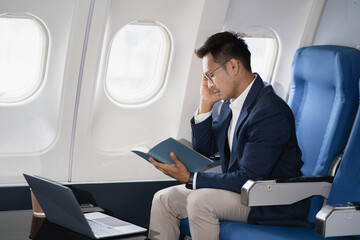 Tired asian man with headache feeling sick while sitting in the airplane , Passengers near the...