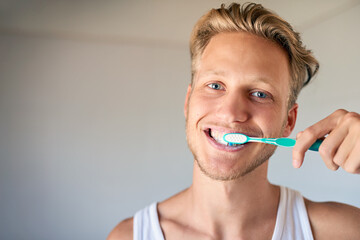 Oral care, portrait and man brushing teeth in home for health, wellness and morning routine. Smile,...