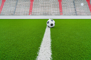 ball on the green field in soccer stadium. ready for game in the midfield