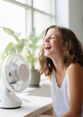 Girl in front of fan on hot summer day
