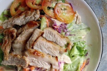 Fresh vegetable salad and pork steak