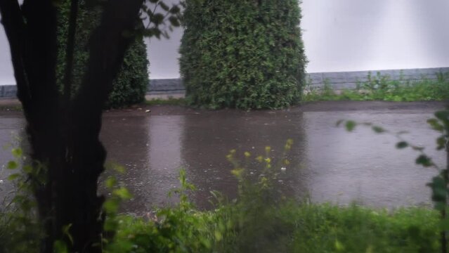 Three white cars drive down the street during the rain. The sign of deja vu as a fixation in the matrix. Signs, hints, omen, symbolism, strange phenomena in life.
