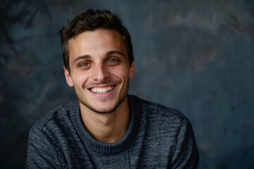 Fototapeta premium Handsome young man smiling in a studio portrait