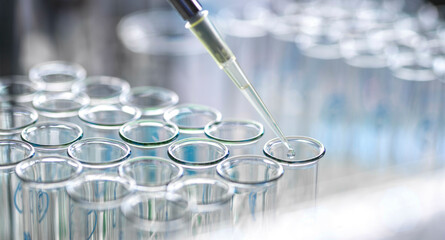 [various]Pharmaceutical Research, scientist pipetting sample into a test tube during an experiment in the lab.  