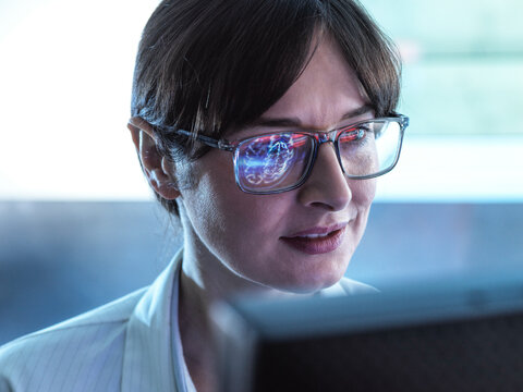 Neurology Research, Scientist viewing a brain scan during a clinical trail looking for disease or damage  
