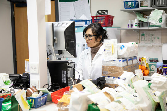 Scientist reviewing items in a laboratory setting.