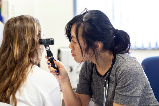Doctor conducting an ear examination in a medical practice