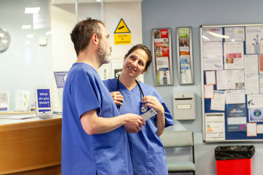 Two healthcare professionals interacting in a hospital setting