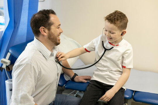 Child playing doctor with an adult doctor