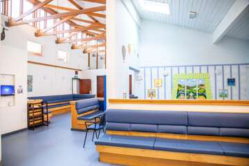 Modern waiting area with comfortable seating and informational displays in a hospital, UK.