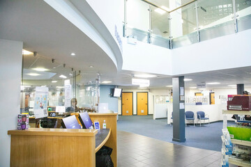 Reception area of a modern hospital with an information desk.