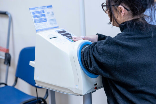 Woman using a white medical device