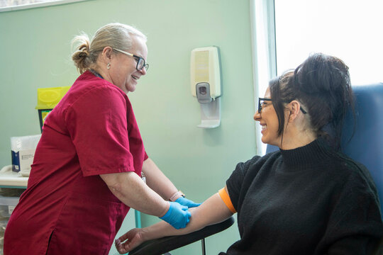 Nurse preparing patient for blood draw 