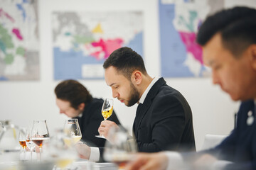 Professional sommelier sniffing unknown whiskey during blind tasting. Sommelier exam to study...