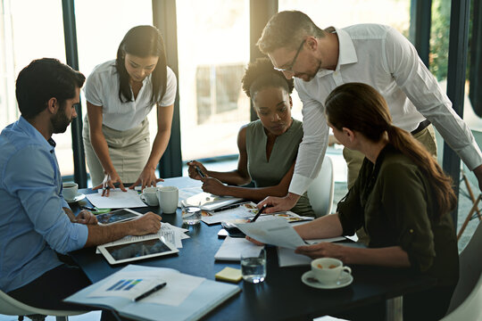 Group, employees and reading in boardroom, paperwork and plan for project, together and business. Workshop, women or men with planning of deal, agency and journalist in office, meeting or discussion