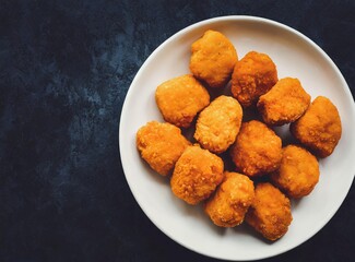 Nuggets isolated on dark rustic background closeup
