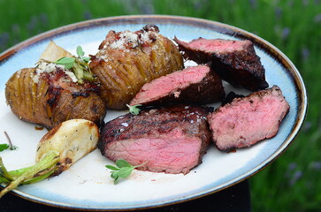 closeup grilled beef meat with vegetables and baked potatoe