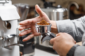 Barista Perfecting Ground Coffee in Portafilter at Espresso Station