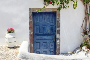 old door of white house in Magalochori town on Santorini island, Greece