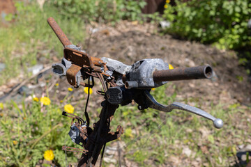 Burned rusty handlebar of motorbike closeup. 
