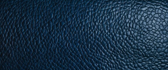 The photo captures the detailed texture of a blue leather surface, focusing on the tactile aspect and richness of the material