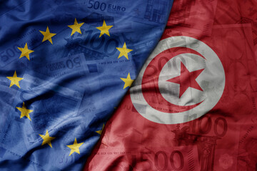 big waving realistic national colorful flag of european union and national flag of tunisia on a...