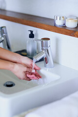 Basin, washing hands and woman with water in bathroom for cleaning, protection and germ...