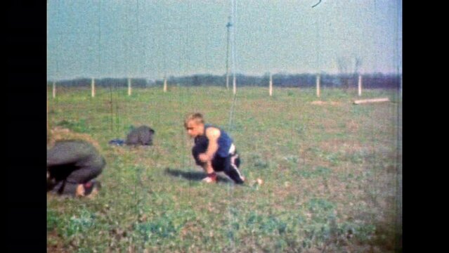 Hand-to-hand combat sparring of young men in kimono, black belt in nature. Man sharpening karate fighting skills, training. Karate fight practice. Asian sport. Vintage color film. Retro 1980s archive