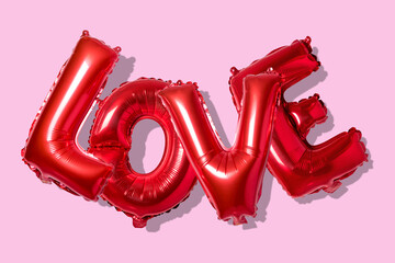 Word love in english alphabet from red balloons on a bright background. Minimal love concept.