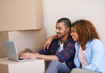 New home, boxes and couple with laptop, smile and property with real estate, cardboard and goals. People, apartment and man with woman, internet or computer to pay mortgage, rent and bonding together
