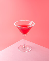 Tropical cocktail on vivid pink background. Minimal summer drink composition.