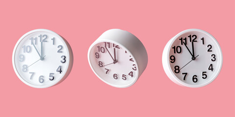 White clock on bright pink background. Minimal time concept.
