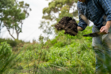 farmer holding soil looking at soil carbon in the america