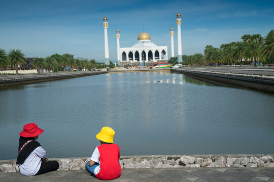 Children of Muslim to sit at Songkhla Central Mosque that suitable place with lake and reflection to visit by Muslim Tourist. Peaceful surroundings at Hatyai , Thailand .