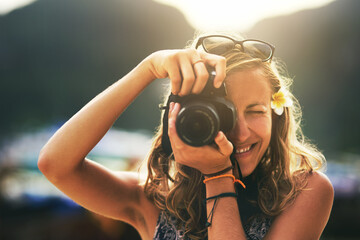 Camera, photographer and woman on vacation outdoor, travel or summer holiday hobby in Switzerland....