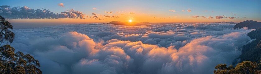 Obraz premium Majestic sunrise above the cloudcovered mountains, casting a golden glow over a serene landscape