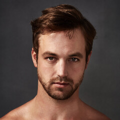 Man, portrait and beauty for skincare in studio, confidence and clean skin on black background,...